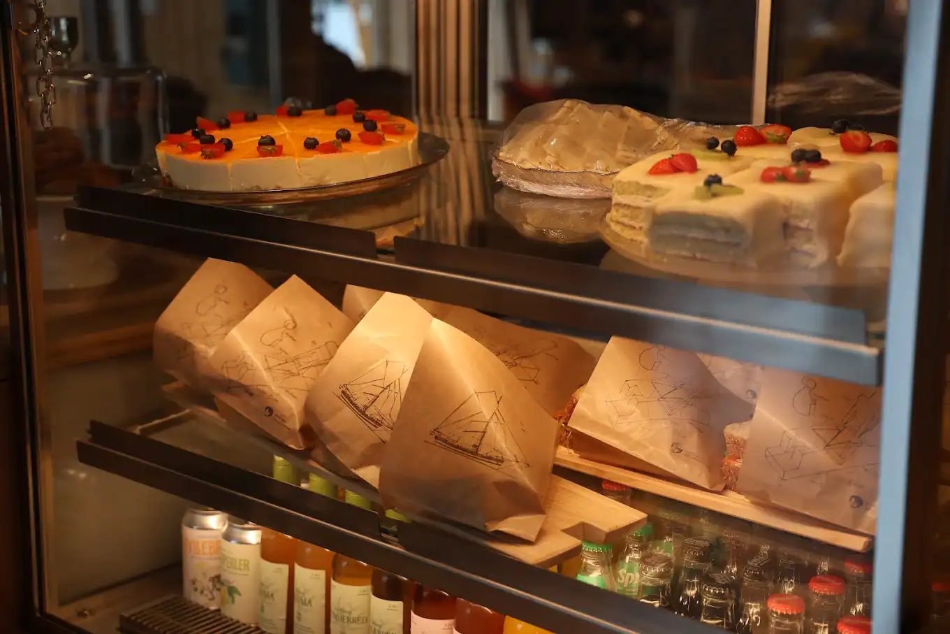 Café offerings at Kulturnaustet. sandwiches and cakes are displayed in a glass cabinet.